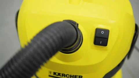 Turn on vacuum cleaner, close up. Man is unrecognizable hand to turn on the Stock Footage 270985425
