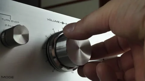 Turn on the volume. turn the knob on the stereo, adjust the volume, the man Stock Footage 149527998