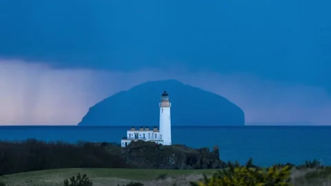 Turnberry Lighthouse and the Ailsa Craig at sunset - 3 Stock Footage 147126826