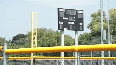 Turned off baseball electronic digital scoreboard on posts in outfield with time Stock Footage 252043172