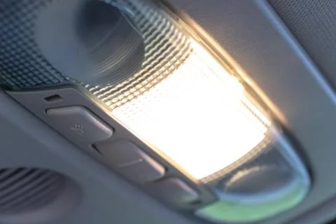 Turned on cabin car ceiling interior lamp, light control panel inside in fron Stock Photos