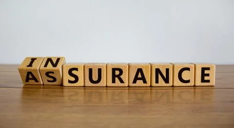 Turned a cube and changed the word assurance to insurance. Beautiful wooden t Stock Photos
