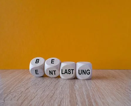 Turned a cube and changes the German expression 'belastung' (strain) to 'entl Stock Photos