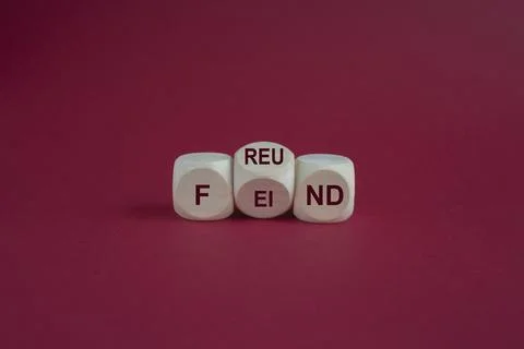 Turned a cube and changes the German word 'Feind' to 'Freund' Stock Photos