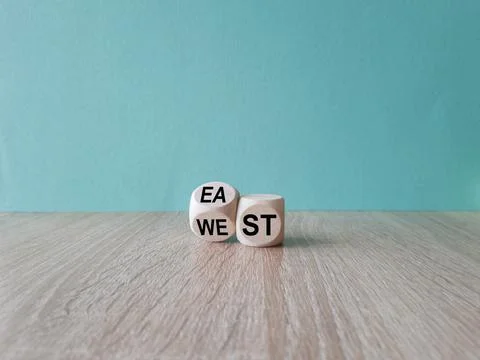 Turned a cube and changes the word east to west, or vice versa. Stock Photos