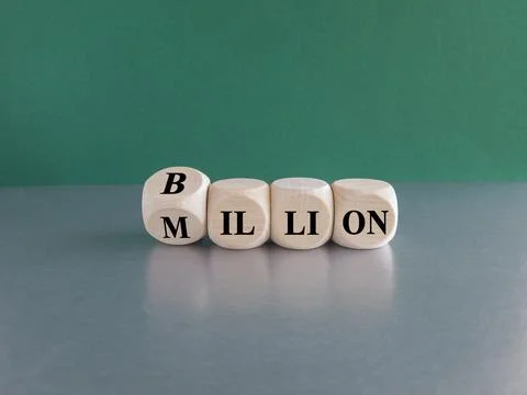 Turned a cube and changes the word Million to Billion. Green background Stock Photos