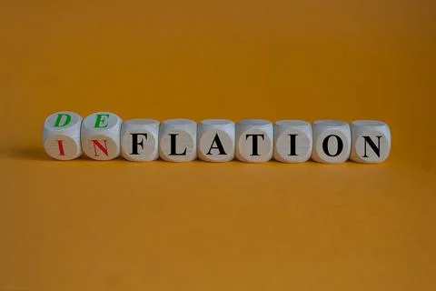 Turned cubes and changed the word inflation to deflation. Stock Photos