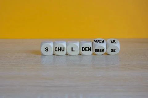 Turned cubes and changes expression Schuldenbremse to Schulden machen Foto stock