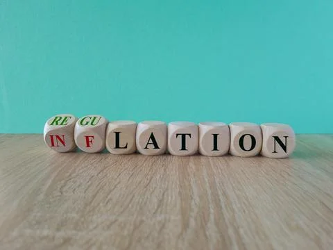 Turned cubes and changes the red word inflation to regulation. Stock Photos