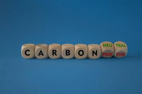 Turned cubes and changes red words carbon positive to carbon neutral. Stock Photos