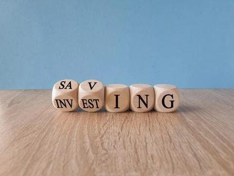 Turned cubes and changes the word 'saving' to 'investing'. Stock Photos