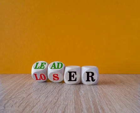 Turned cubes and changes the word loser to leader. Beautiful wooden table Stock Photos