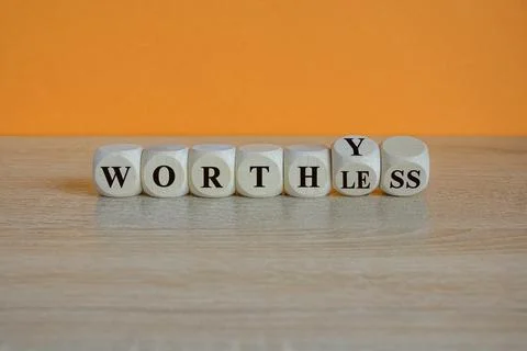 Turned cubes and changes the word WORTHLESS to WORTHY Stock Photos