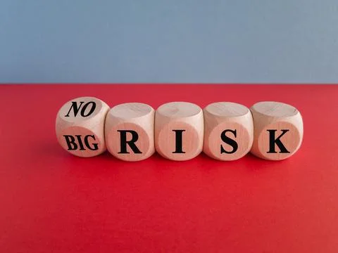 Turned a dice and changes the expression "big risk" to "no risk". Stock Photos