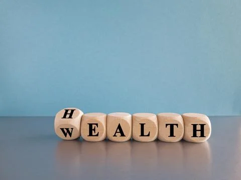 Turned a dice and changes the expression HEALTH to Wealth (or vice versa). Stock Photos