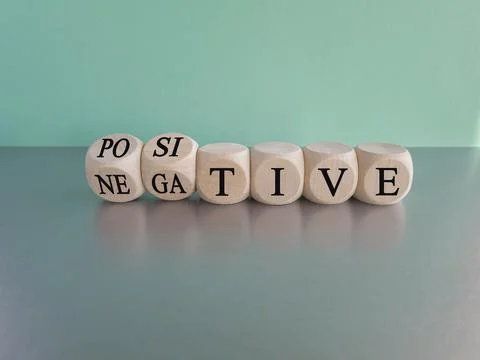 Turned a dice and changes the expression "negative" to "positive". Stock Photos