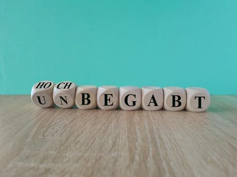 Turned dice and changes the German expression unbegabt (unskilled) to hochbeg Stock Photos