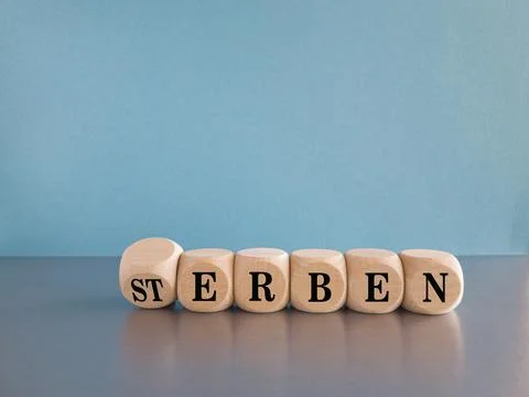 Turned dice and changes the German word 'Sterben to erben Stock Photos