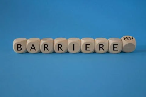Turned a dice and changes the German word Barriere to Barrierefrei. Stock Photos