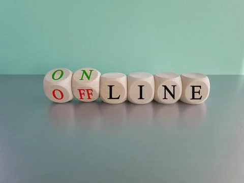 Turned a dice and changes the word OFF LINE to ON LINE. Stock-Fotos