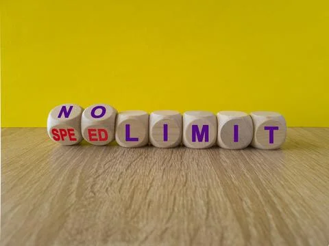 Turned dices and changes the expression speed limit to no limit Stock Photos