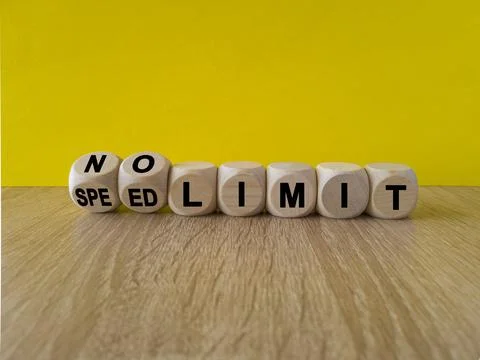 Turned dices and changes the expression speed limit to no limit Stock Photos