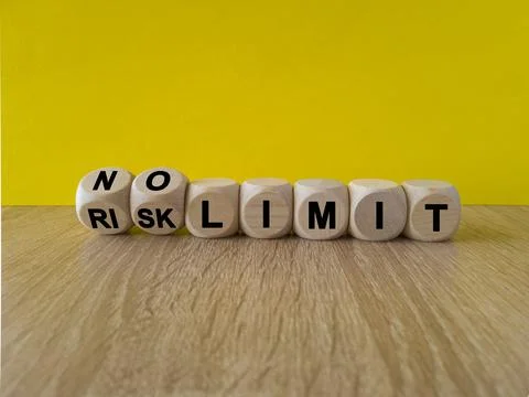 Turned dices and changes the expression RISK LIMIT to NO LIMIT. Foto stock
