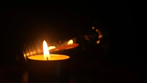 Turned off Light Bulb Next to a Burning Candle. Blackout Concept, Blackout City Stock-Footage 320191703