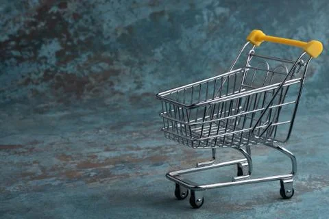 Turned pushcart empty on navy blue background, Black Friday concept. Stock Photos