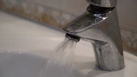 Turned on the tap in the bathroom. Clear, clean water flows from the tap Stock Footage 235891427