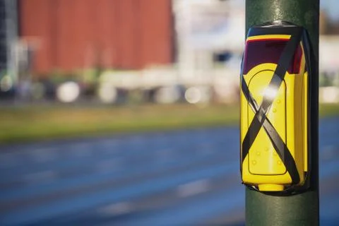 Turned off a traffic light button for crossing roadway with blurred bus. Cros Stock Photos