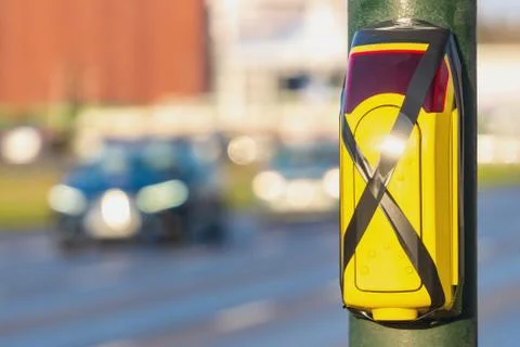 Turned off a traffic light button for crossing roadway with blurred bus. Cros Stock Photos