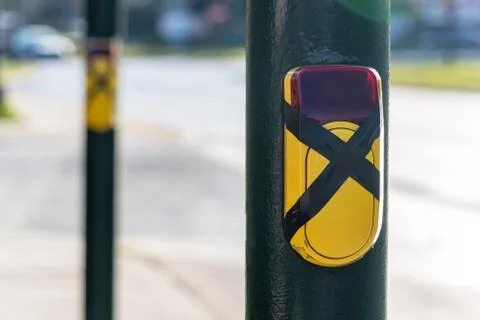 Turned off a traffic light button for crossing roadway with blurred bus. Cros Stock Photos