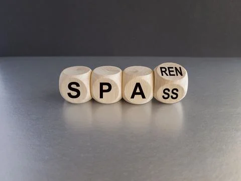 Turned a wooden cube and changes the German word spass to sparen. Stock-Fotos