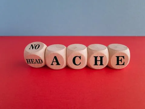 Turned a wooden cube and changes the word headache to no ache. Stock Photos