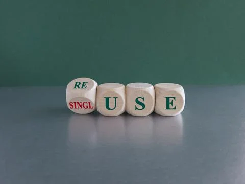 Turned a wooden cube and changes the green word single use to reuse. Foto stock