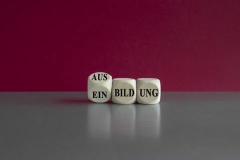 Turned a wooden cube and changes the German word Einbildung to Ausbildung Stock Photos