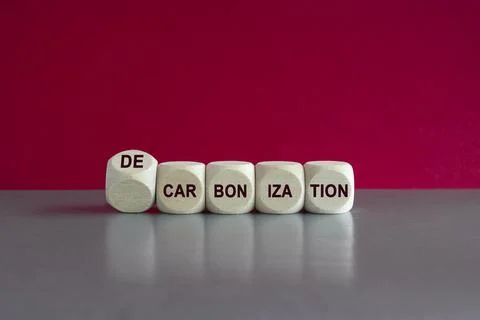 Turned wooden cube and changes words carbonization to decarbonization. Stock Photos