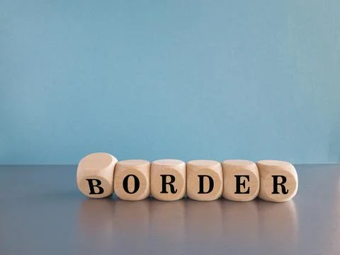 Turned wooden cube and changes the word border to order. Stock Photos