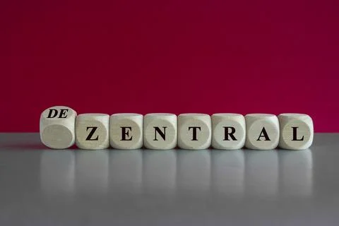 Turned wooden cube and changes the German word 'zentral' (centralized) Stock Photos
