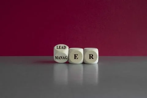 Turned a wooden cube and changes the word 'manager' to 'leader'. Stock-Fotos