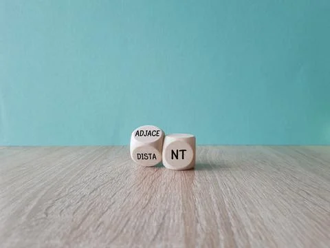 Turned a wooden cube and changes words Distant to Adjacent. Stock Photos