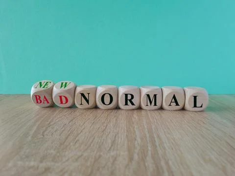 Turned wooden cubes and changes words bad normal to new normal. Stock Photos