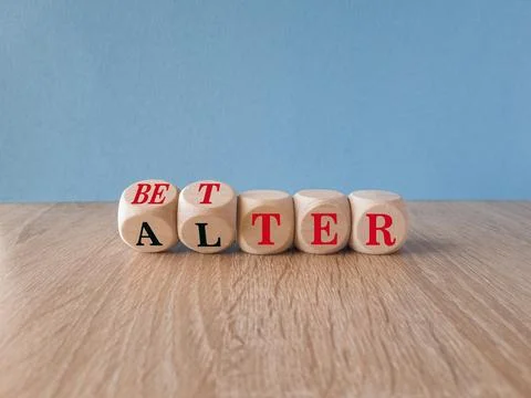 Turned wooden cubes and changes the word alter to better. Stock Photos
