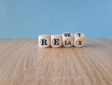 Turned wooden cubes and changes the red word relax to reset. Stock-Fotos