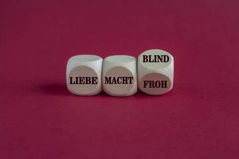 Turned a wooden cubes and changes liebe macht froh to liebe macht blind Stock Photos