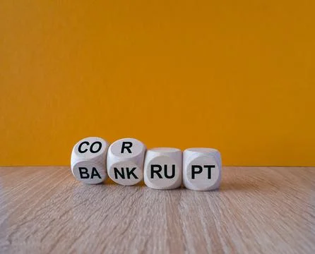 Turned wooden cubes and changes the expression bankrupt to corrupt Foto stock