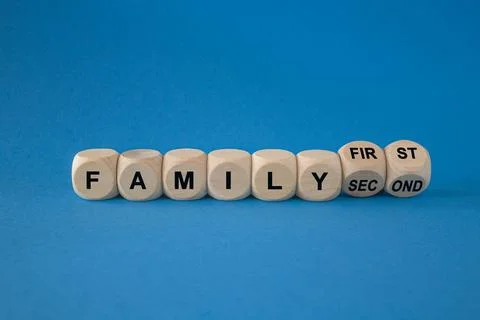 Turned wooden cubes and changes the expression family second to family first Stock Photos