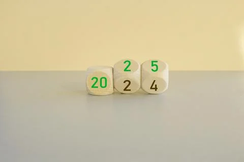 Turned wooden cubes and changes number 2024 to 2025. Stock Photos