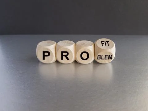 Turned wooden cubes, changes the word 'problem' to 'profit'. Stock-Fotos
